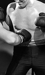cropped photo of boxer taking a punch in the stomach
